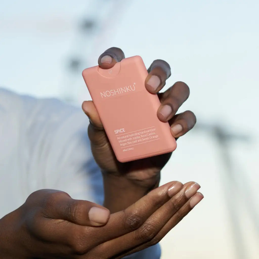 Pink compact mirror with sleek rectangular design and rounded edges for Orange Coriander hand sanitizer