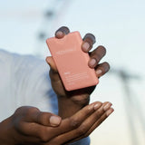 Pink compact mirror with sleek rectangular design and rounded edges for Orange Coriander hand sanitizer