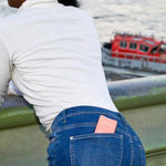 Blue denim jeans with white stitching and pockets