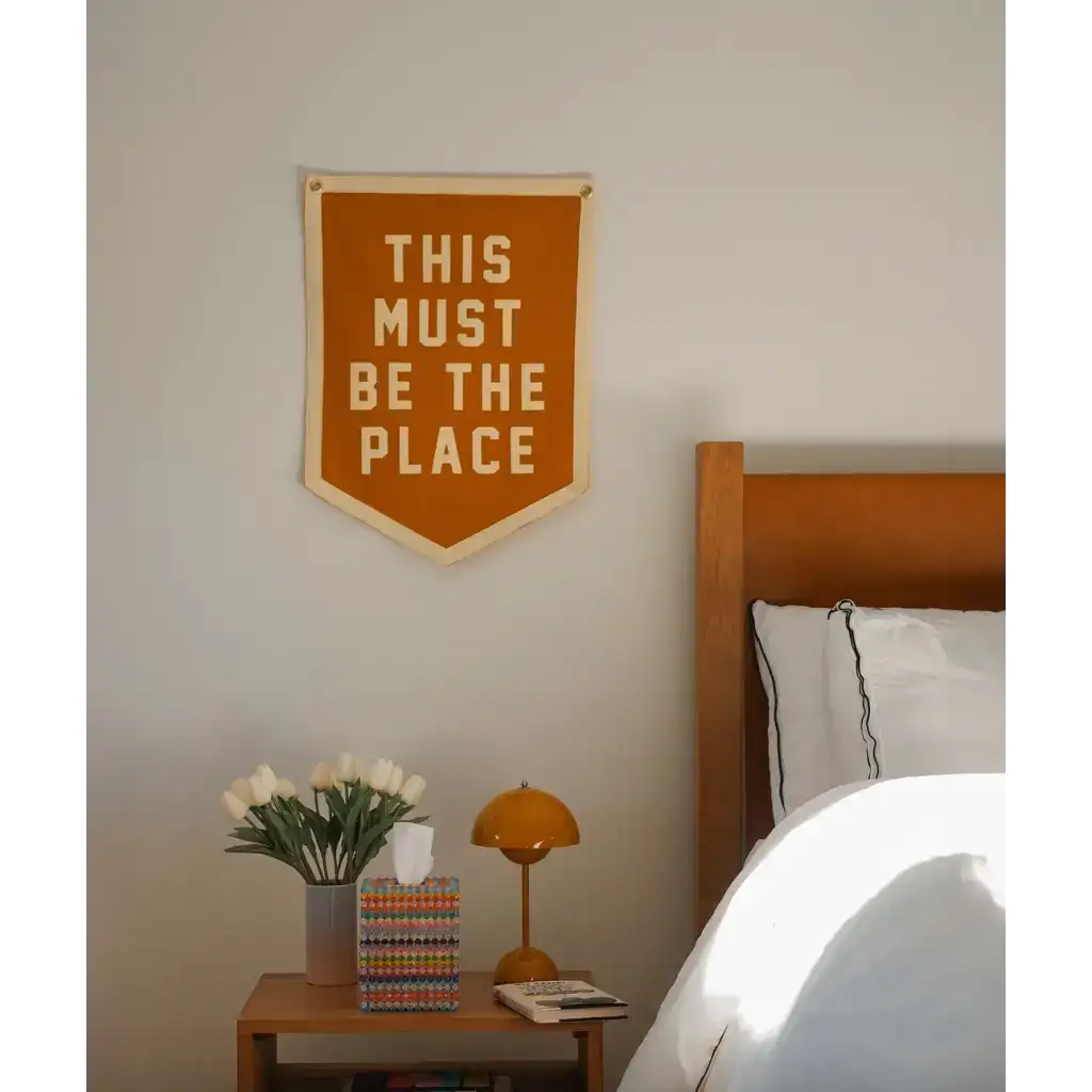 Orange pennant flag with white lettering for This Must Be the Place Camp Flag, stylish decor