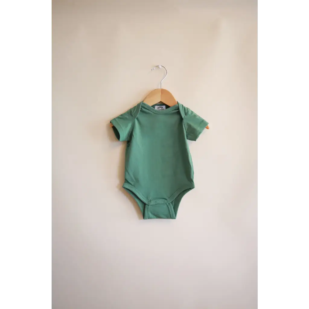 Sage green short-sleeved baby bodysuit on a hanger, made from organic cotton in Dark Ivy