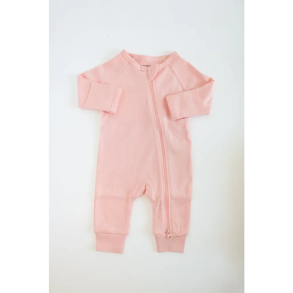 Pink zip-up baby romper in organic cotton, perfect for cozy sleep in earthy colors