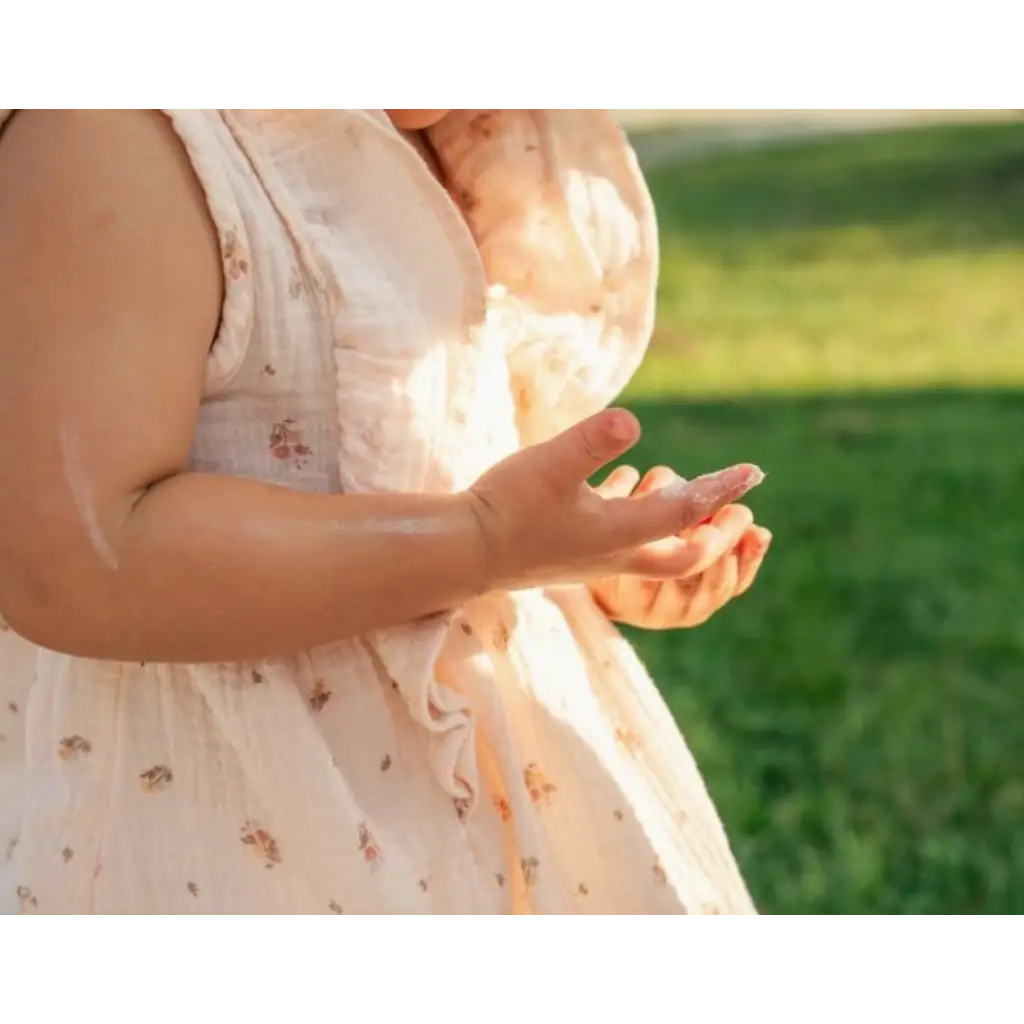 Child’s floral dress in product shot for Organic Tallow Baby Balm with pasture raised beef tallow