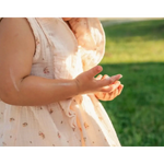 Child’s floral dress in product shot for Organic Tallow Baby Balm with pasture raised beef tallow