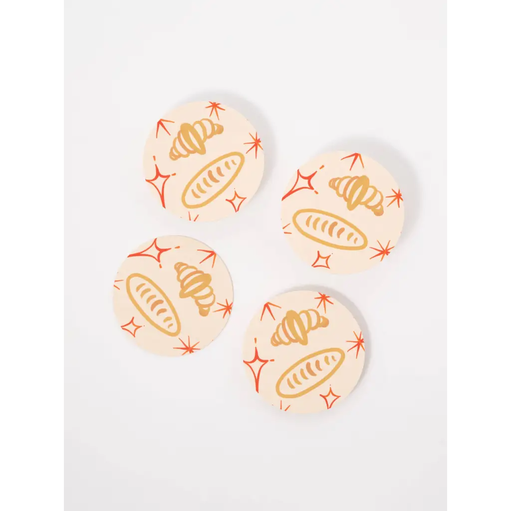 Four stylish coasters with croissant and baguette designs, perfect for stylish womens clothes or moms homes