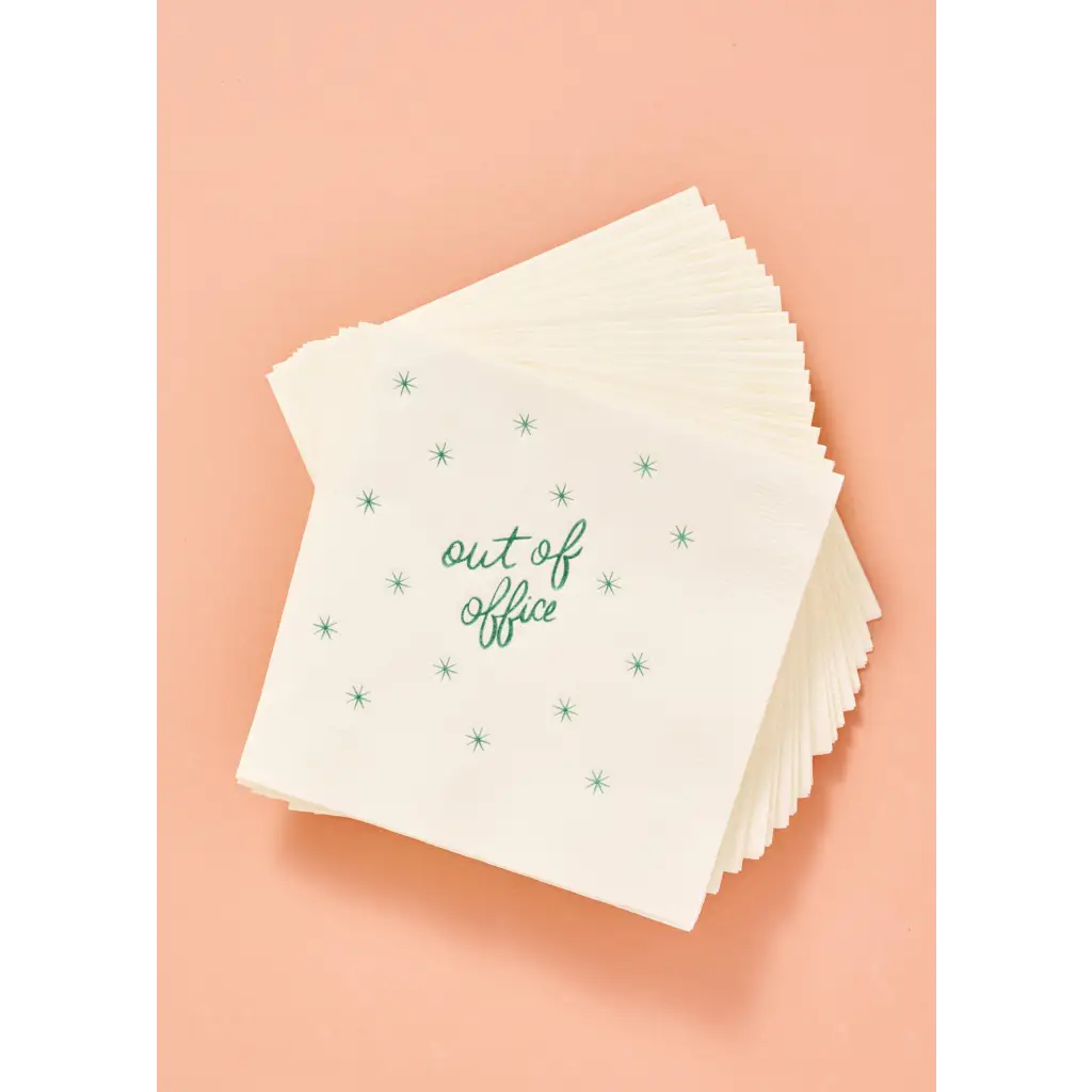 Stack of white cocktail napkins with green star pattern for stylish womens clothes or parties