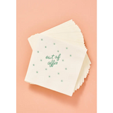 Stack of white cocktail napkins with green star pattern for stylish womens clothes or parties