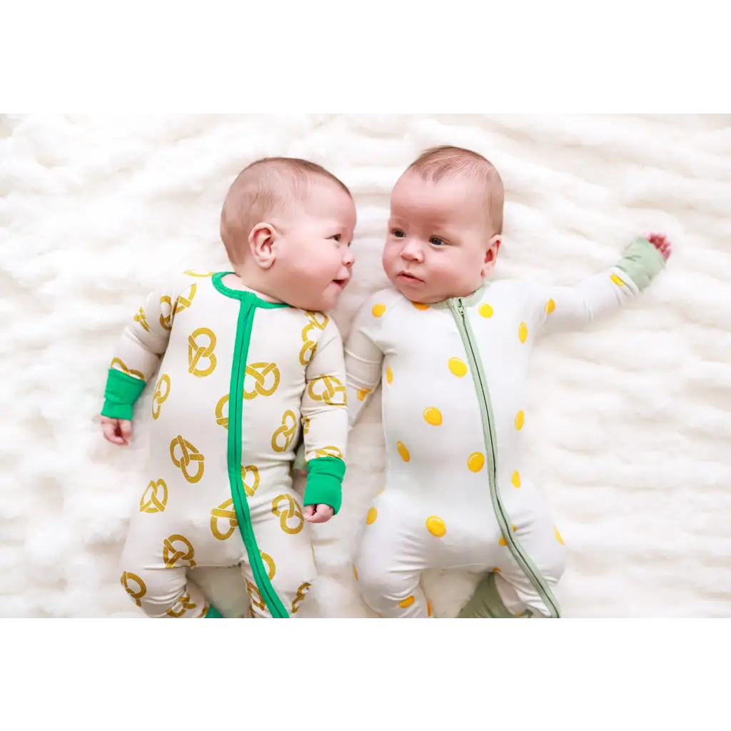 Two adorable babies in patterned easy bamboo sleepers, ready for cozy snuggles