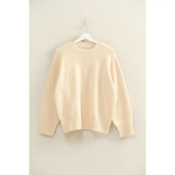 Cream-colored oversized drop shoulder sweater with ribbed cuffs