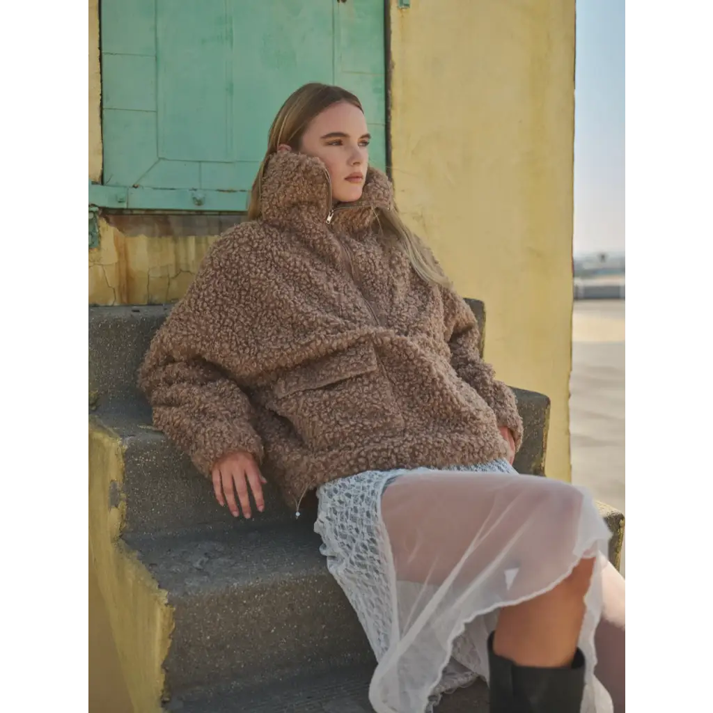 Cozy brown sherpa fleece half-zip pullover jacket styled with a white lace skirt