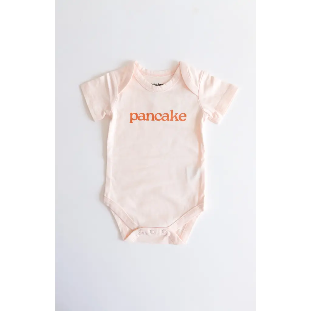 Light pink pancake organic cotton onesie for cozy cuties with fun orange text