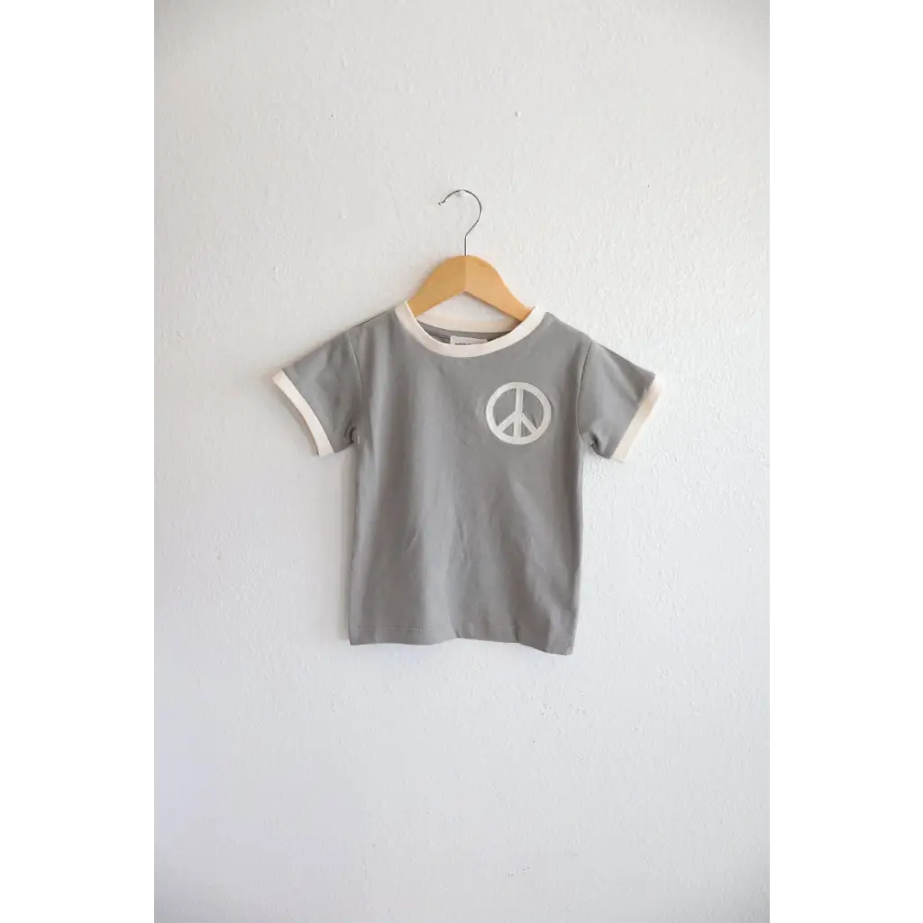 Gray Everyday Ringer Tee with White Peace Symbol Design on Wooden Hanger