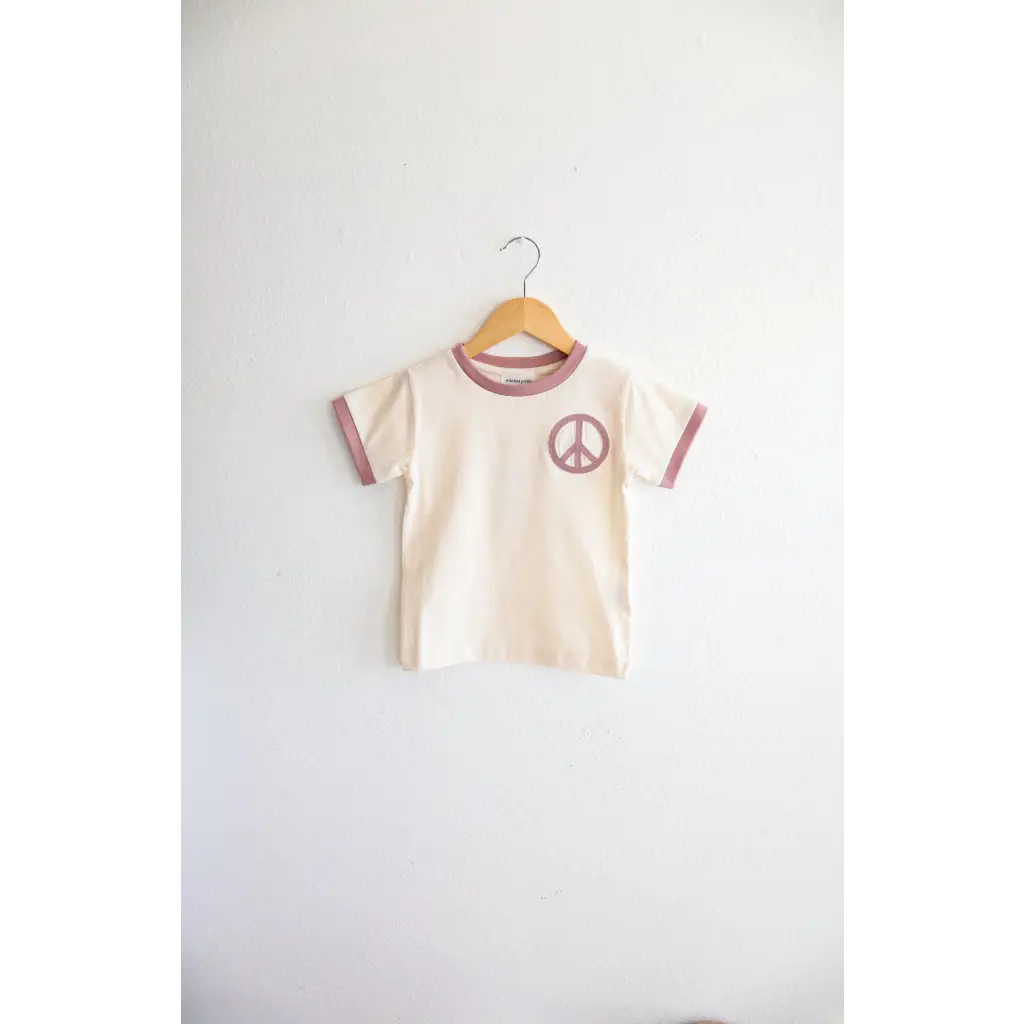 Cream Peace Embroidered Ringer Tee for Kids on a hanger, perfect everyday ringer