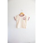 Cream Peace Embroidered Ringer Tee for Kids on a hanger, perfect everyday ringer