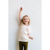 Joyful child in Cream Peace Embroidered Ringer Tee, perfect everyday ringer for kids