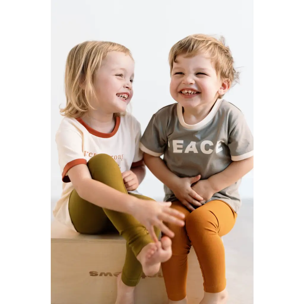 Two laughing kids in casual clothes wearing Everyday Ringer Tee for a fun vibe