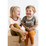 Two laughing kids in casual clothes wearing Everyday Ringer Tee for a fun vibe