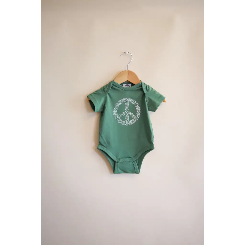 Green baby onesie with peace symbol design from the Peace Floral Organic Cotton collection