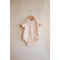 Pale pink Peace Floral Organic Cotton Baby Onesie hanging on wooden hanger