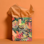 Tropical gift bag with polished prints, gold handles, perfect for stylish womens clothes or moms