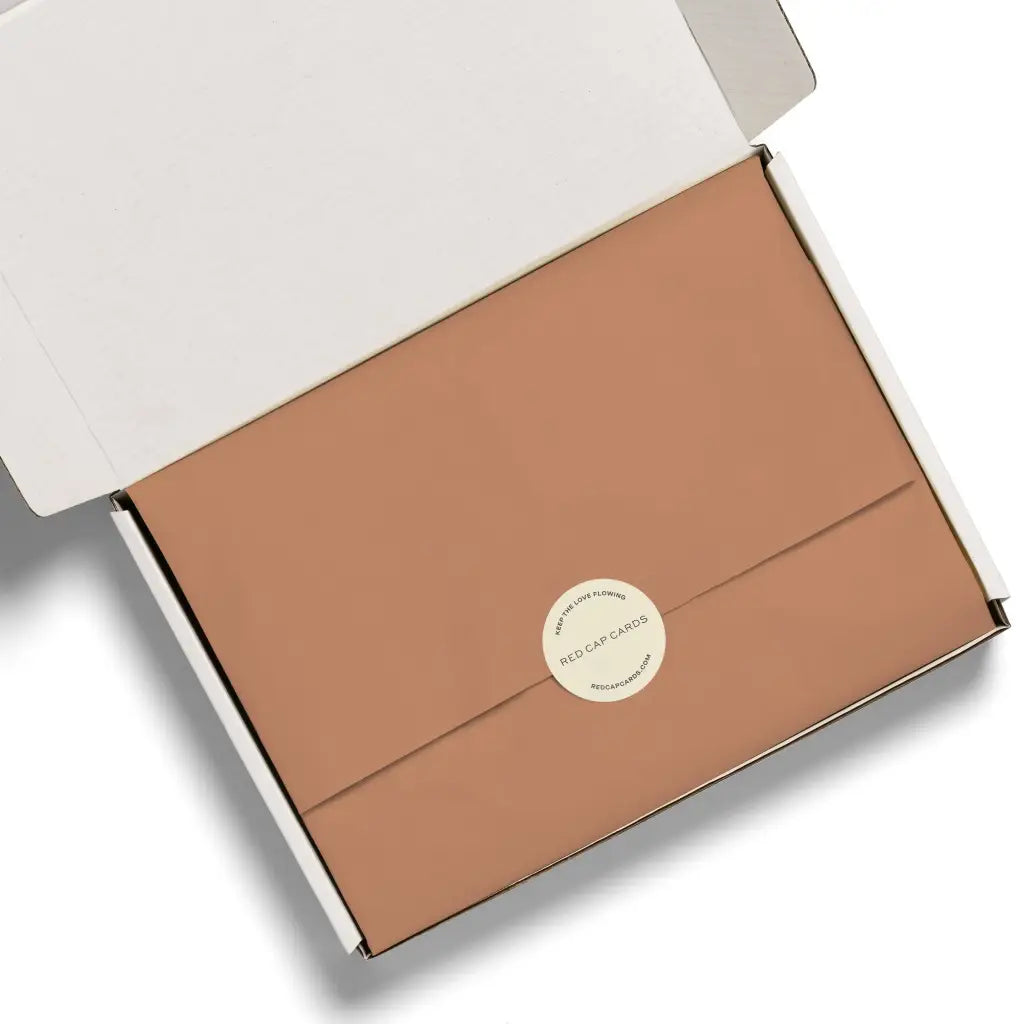 Rose gold rectangular box with circular sticker for Peach tissue paper, perfect for stylish womens clothes