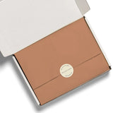 Rose gold rectangular box with circular sticker for Peach tissue paper, perfect for stylish womens clothes