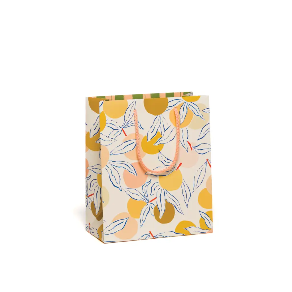 Yellow and orange citrus-themed gift bag with green leaves and rope handles for stylish womens clothes