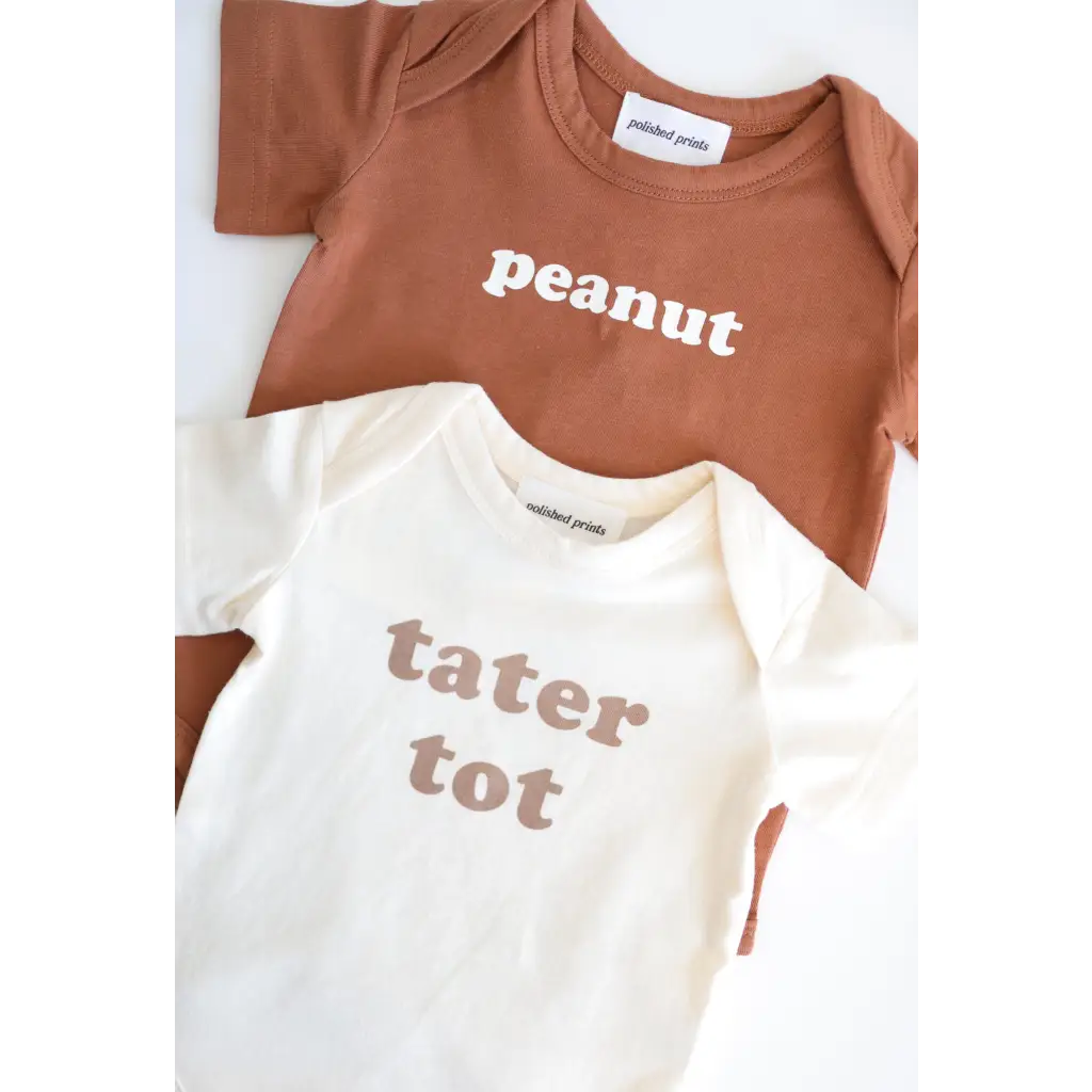 Two baby onesies in organic cotton, brown Peanut and white Tater Tot for 3mo fits