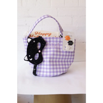 Purple gingham Halloween basket with black cat mask and spooky pins for stylish womens clothes