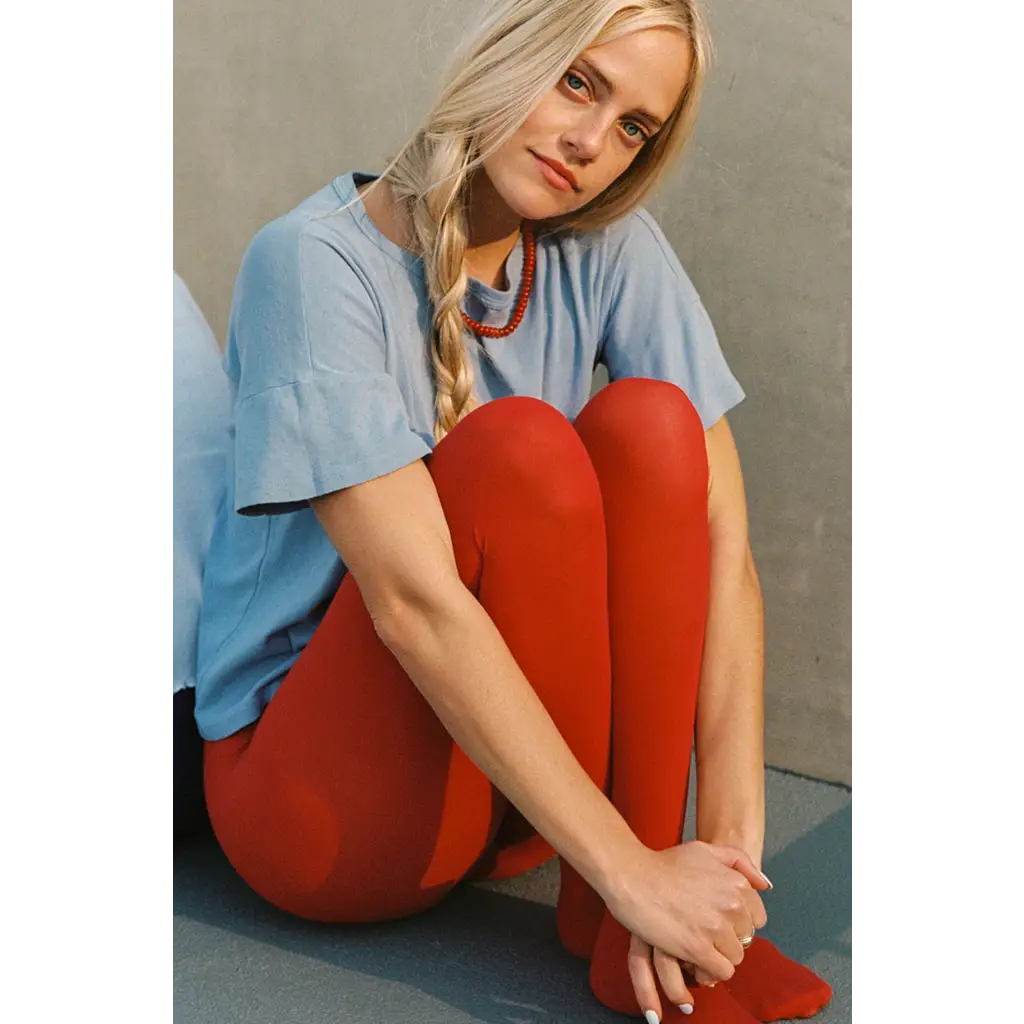 Petit pointelle tee with vibrant red organic cotton leggings on model
