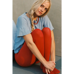 Petit pointelle tee with vibrant red organic cotton leggings on model
