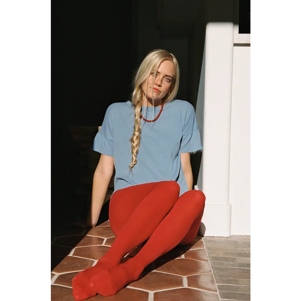 Woman in petit pointelle organic cotton tee with red tights