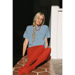 Woman in petit pointelle organic cotton tee with red tights