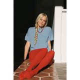 Woman in petit pointelle organic cotton tee with red tights