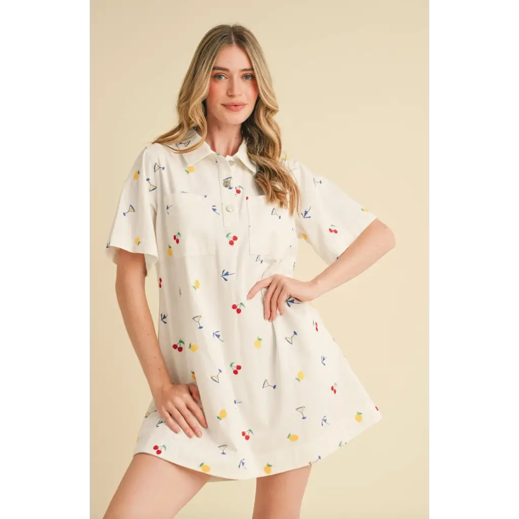 Women’s white collared mini dress with colorful fruit and drink pattern for a fun picnic look