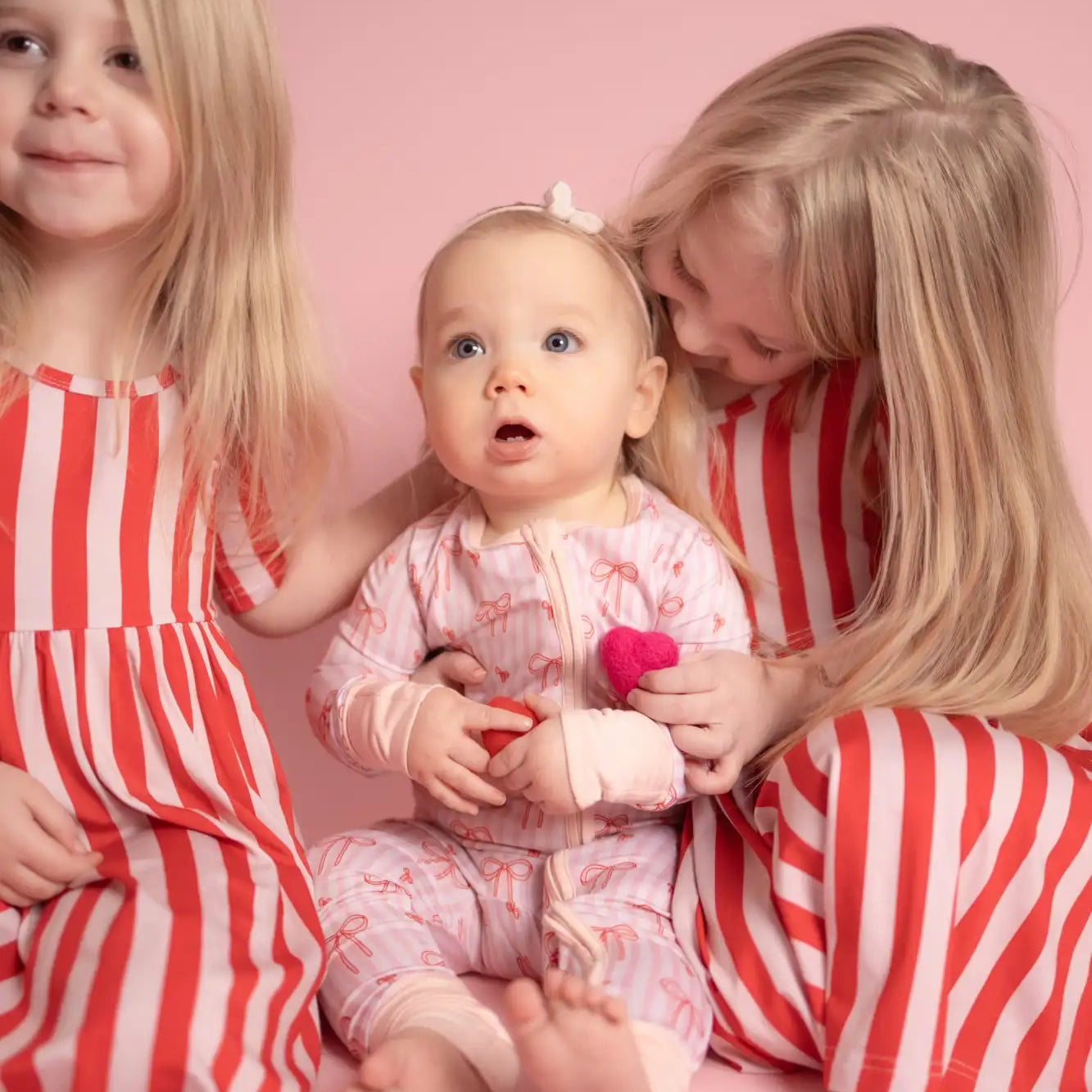 Pink and white striped pajama set with heart patterns