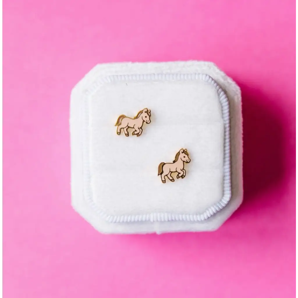 Gold horse stud earrings in a jewelry box, perfect hypoallergenic earrings for active girls