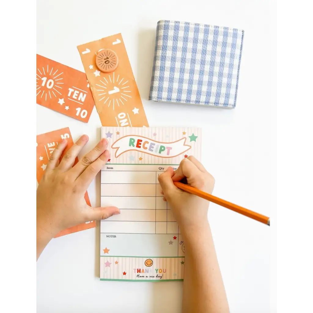 Colorful pretend play receipt notepad with orange tickets and blue gingham napkin