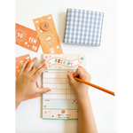 Colorful pretend play receipt notepad with orange tickets and blue gingham napkin