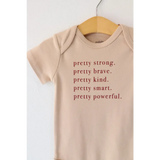 Beige Pretty Brave Organic Cotton Baby Onesie with empowering text for babies