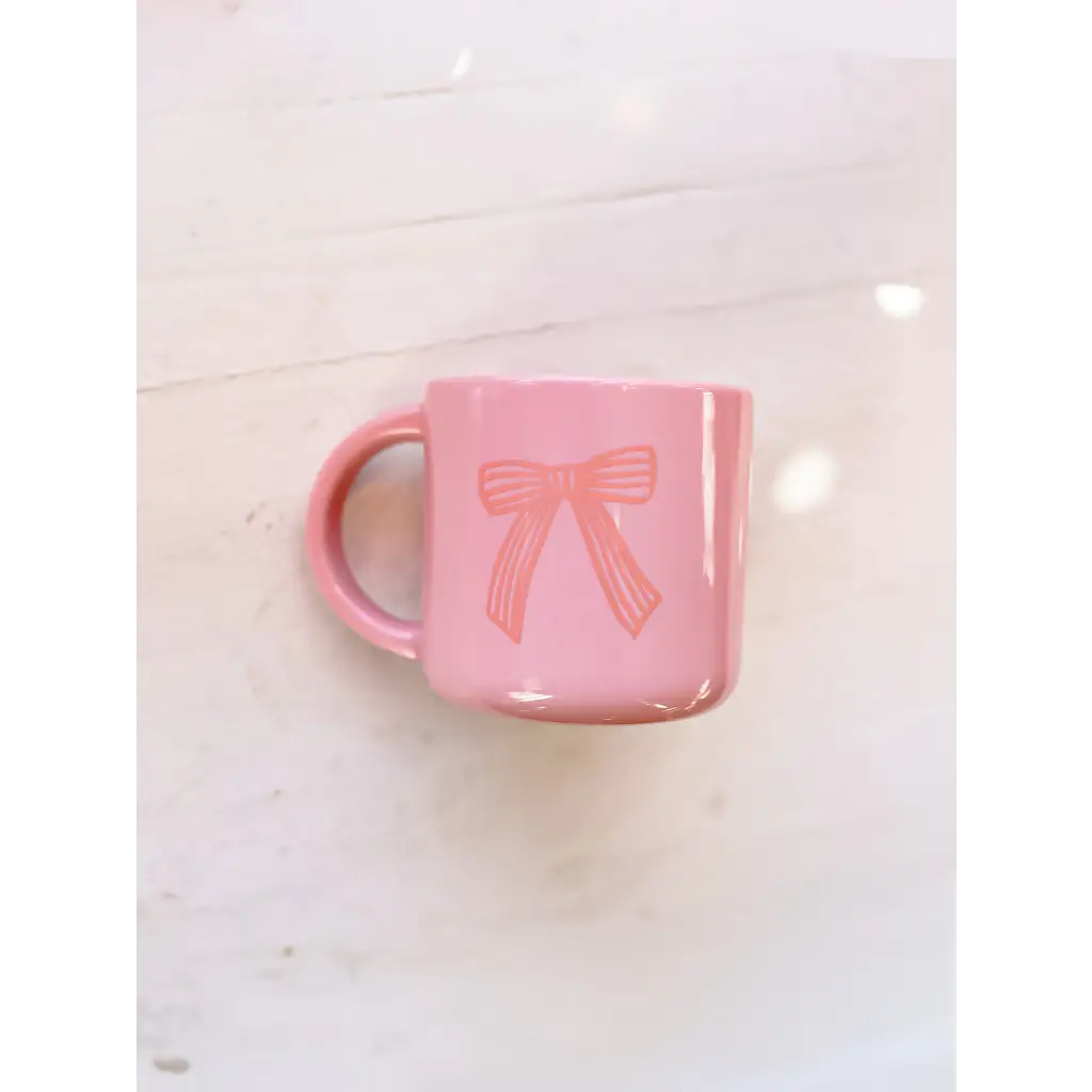 Pink ceramic mug with a cute bow design, perfect for your Campfire Mug collection