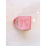 Pink ceramic mug with a cute bow design, perfect for your Campfire Mug collection