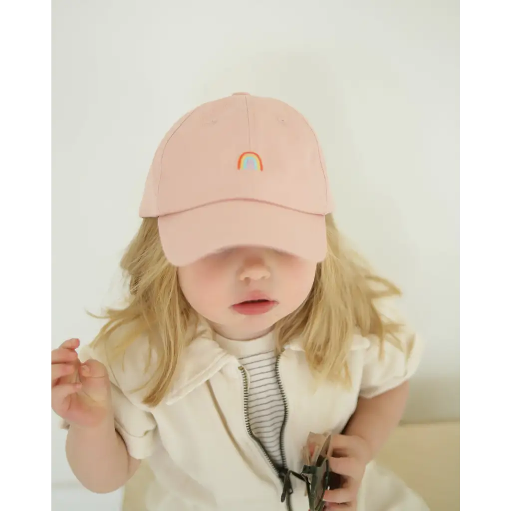 Pink kids ball cap featuring a cute rainbow patch for cheerful little adventures