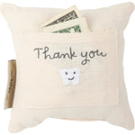 Off-white tooth fairy pillow with thank you embroidered pocket and smiling tooth holding dollar bills