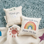 Cream-colored rainbow tooth fairy pillow with embroidered plea