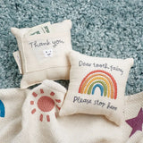 Cream-colored rainbow tooth fairy pillow with embroidered plea