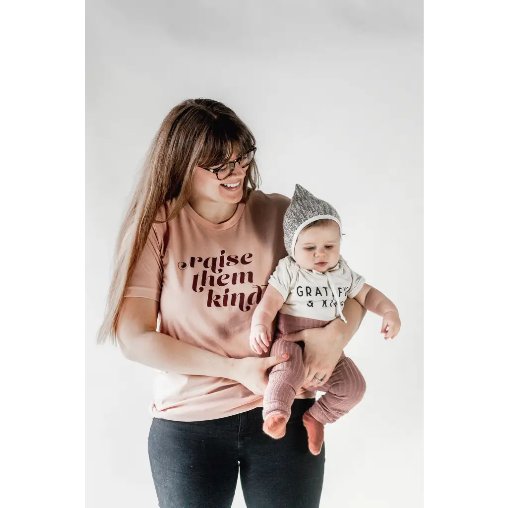 Parent and baby in matching organic cotton graphic t-shirts in pink and gray
