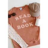 Terracotta organic cotton lightweight pullover with READ A BOOK in pink letters