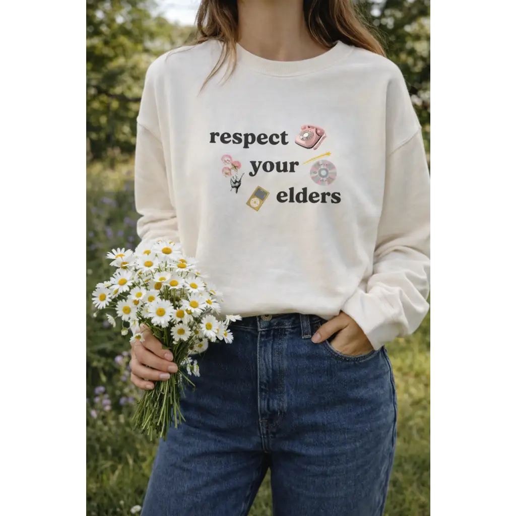 Cream-colored Respect Your Elders pullover with polished prints and broken-in feel