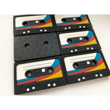 Retro cassette tape teether featuring black tapes with colorful diagonal stripes